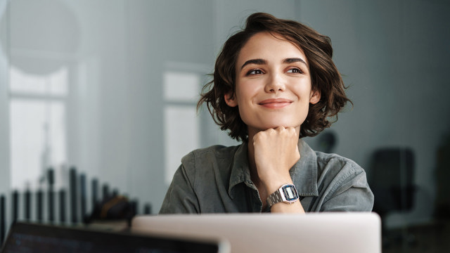 happy female Andersen worker at desk